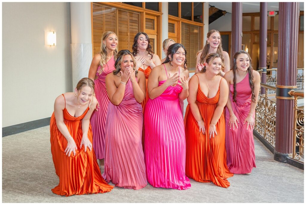 bride having a first look with her bridesmaids on the balcony at the Arcade venue