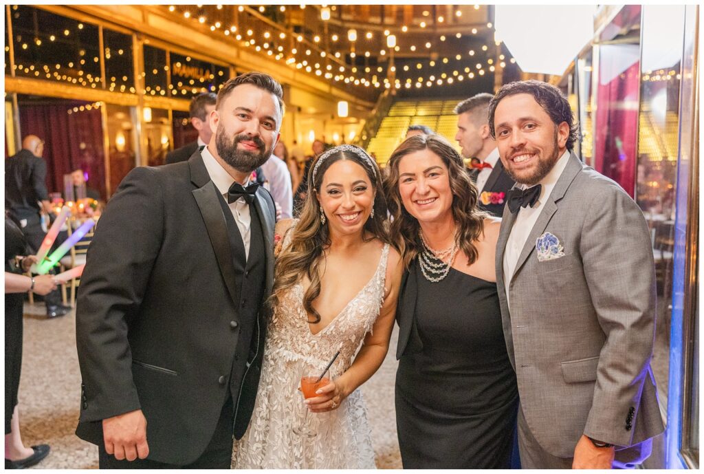 groom and bride posing with friends at Cleveland Arcade venue