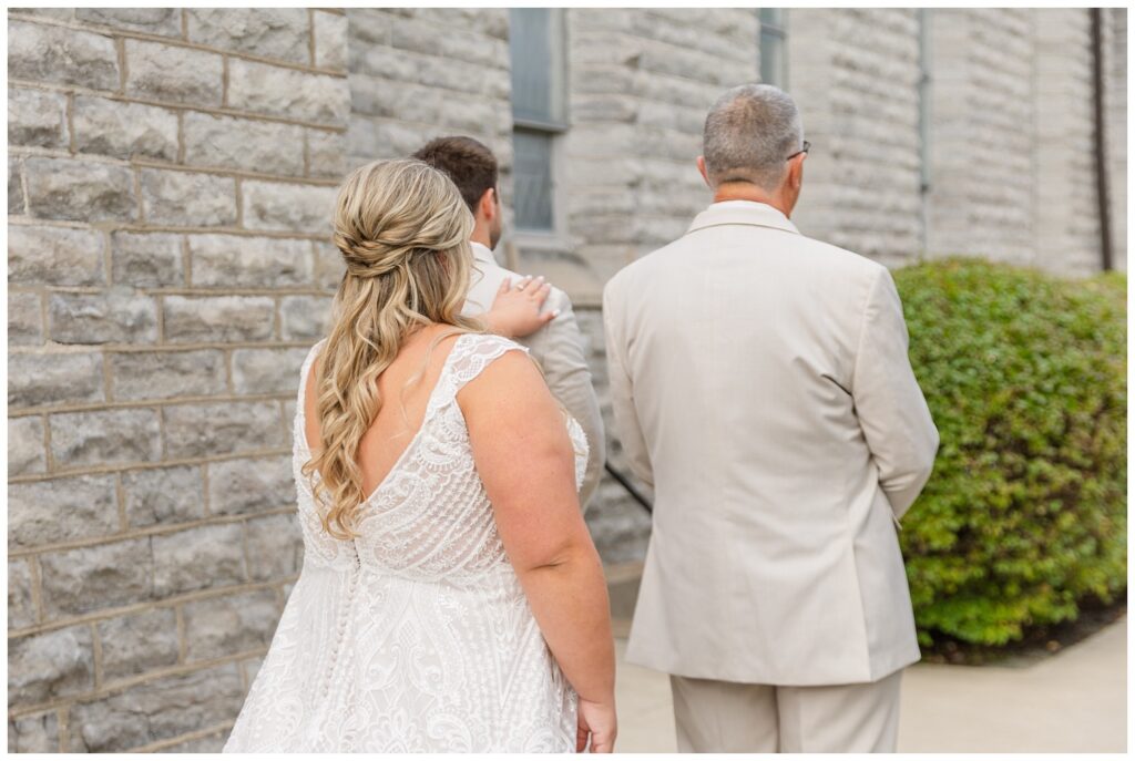 first look with the bride's dad and her brother outside the church