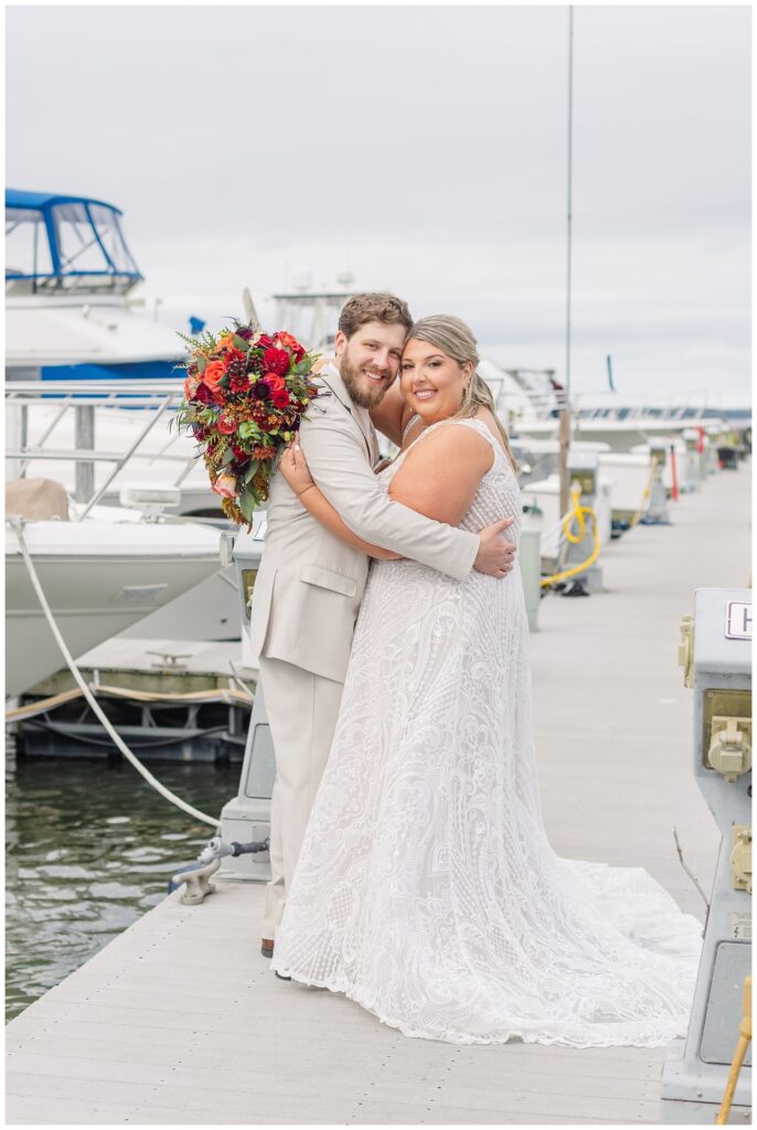 wedding couple hugging on the gangway at the boats at the Sandusky Yacht Club