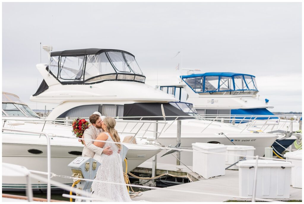 wedding couple kissing on the gangway at the boats at the Sandusky Yacht Club in Ohio