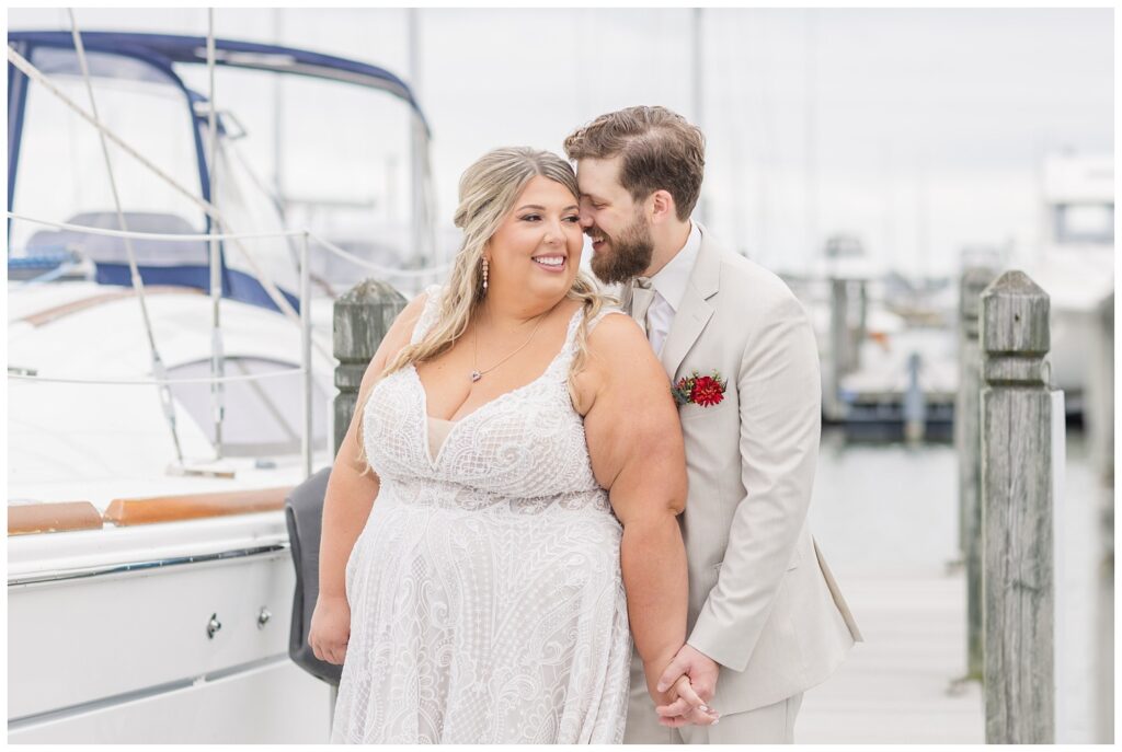 wedding couple laughing and smiling together next to boats at yacht club in Sandusky