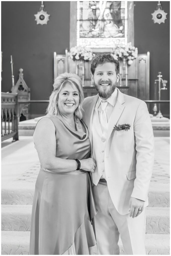 groom posing with his mom inside the church after the ceremony in Ohio