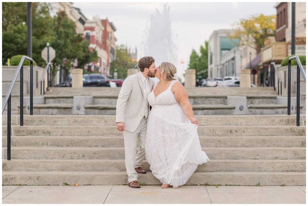 wedding couple kissing near the fountain in downtown Sandusky