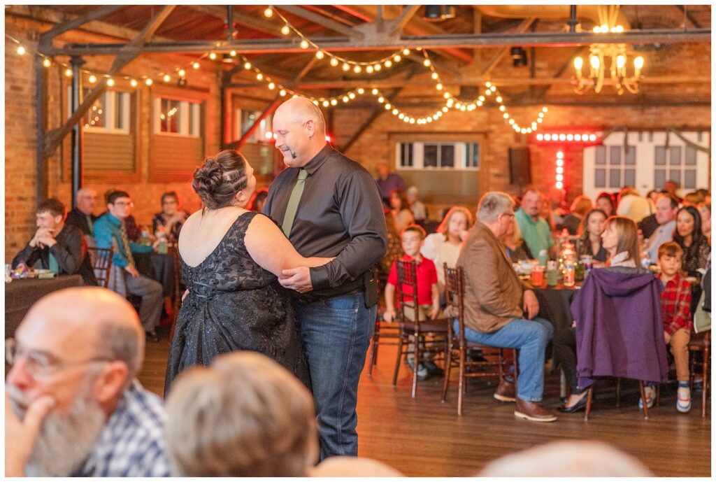 bride and groom have first dance after eating dinner at Pickwick Place wedding reception