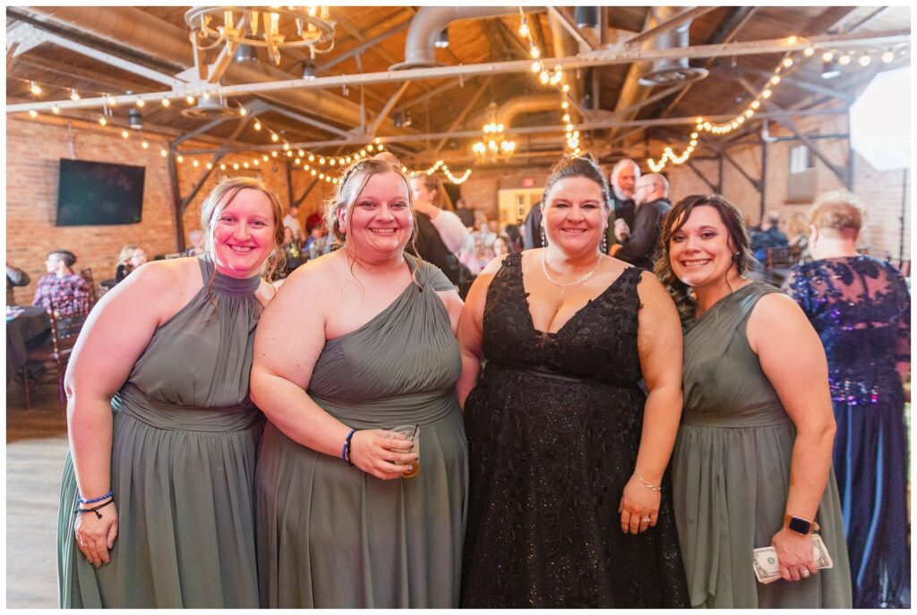 bride posing with some of her bridesmaids on the dance floor in Bucyrus, Ohio