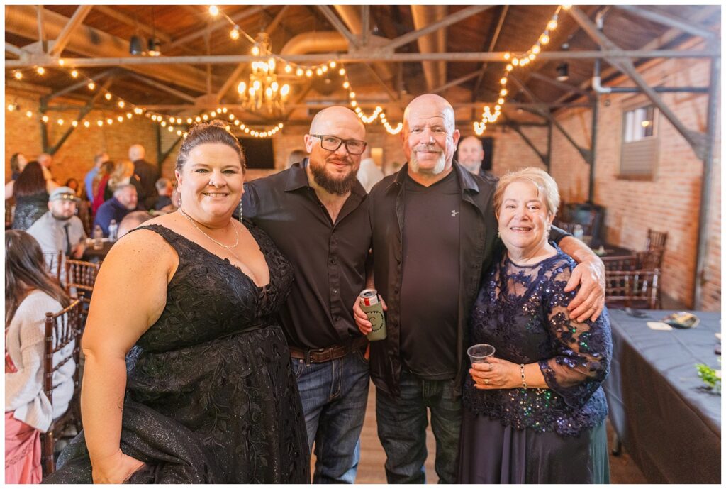 bride posing with some family members at wedding reception at Pickwick Place