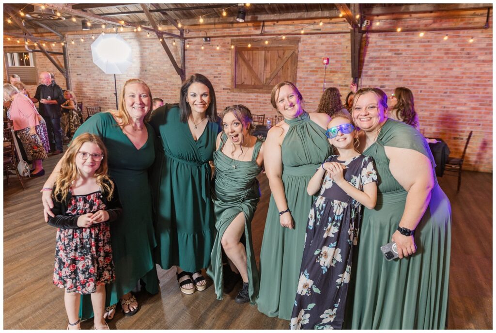 bridesmaids and friends posing together on the dance floor in Bucyrus, Ohio