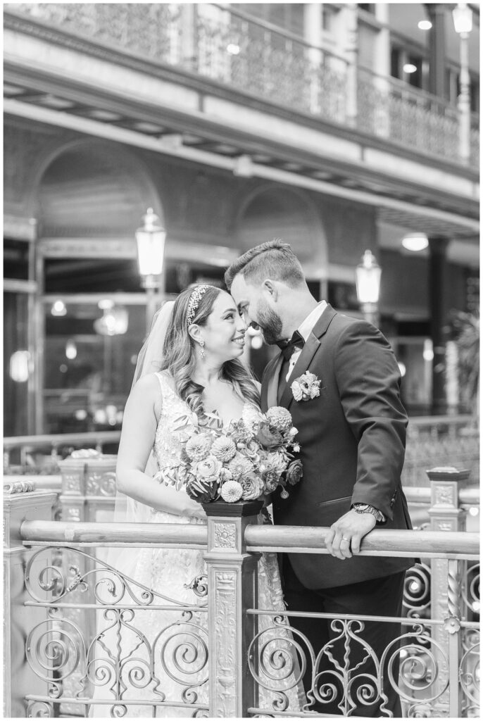 wedding couple touching foreheads at the balcony at the Arcade