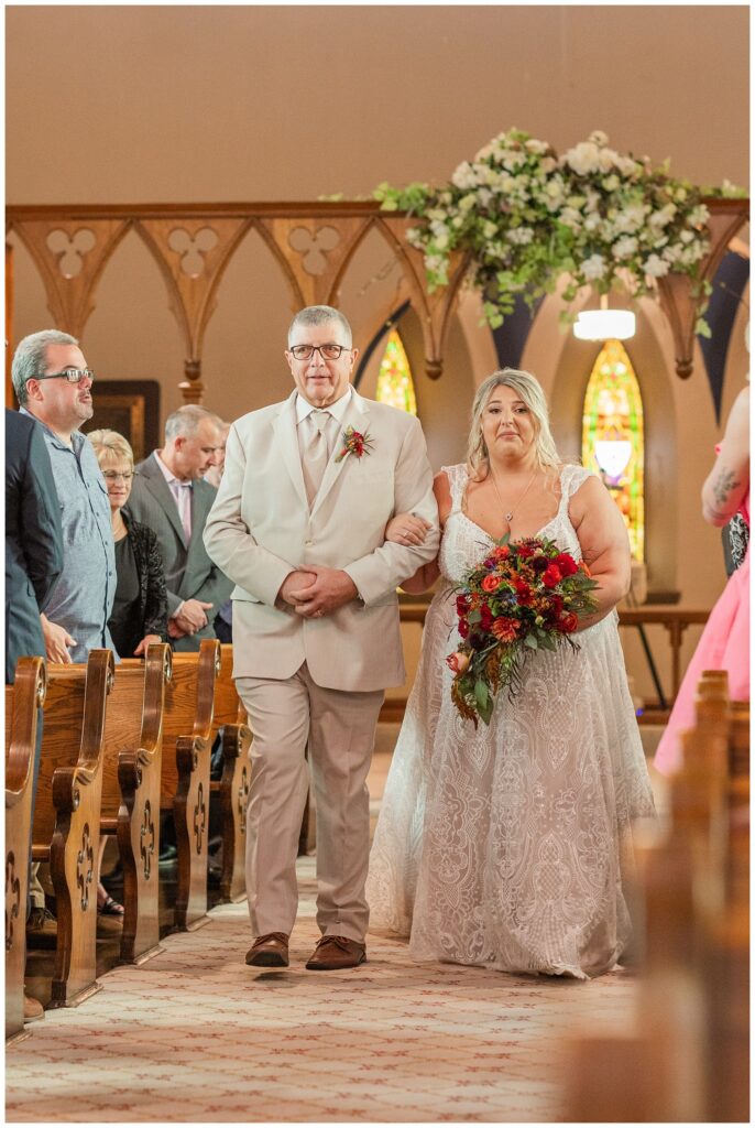 bride walking down the aisle with her dad at Old Calvary Church in Sandusky, Ohio