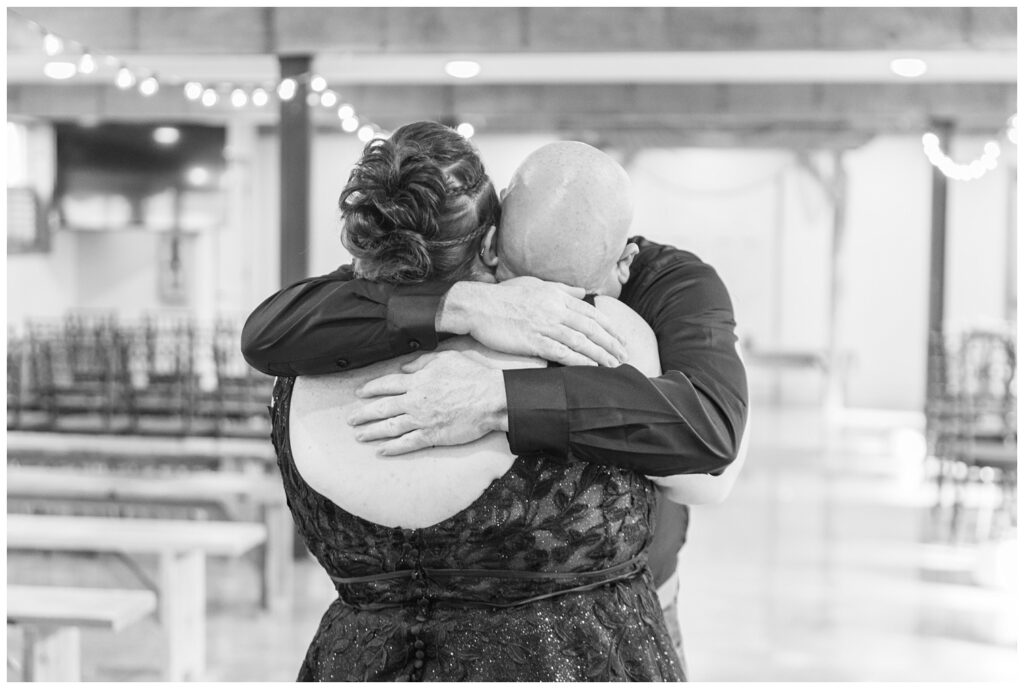 bride's dad giving her a big hug at the ceremony chapel before the wedding