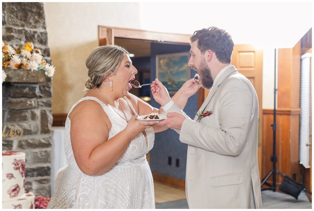 bride and groom feeding each other cake at Sandusky, Ohio wedding reception