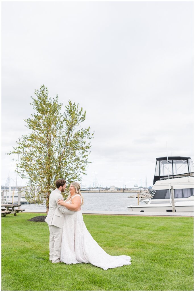 bride and groom having first look near the water at Sandusky Yacht Club