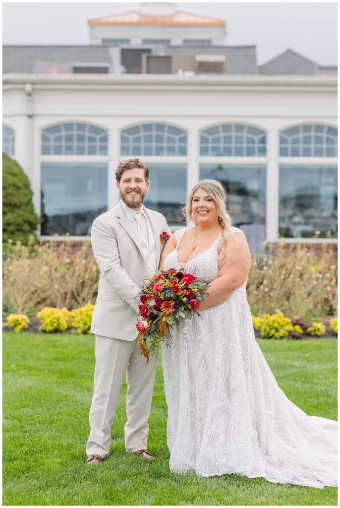 wedding couple posing in front of the Sandusky Yacht Club in Ohio