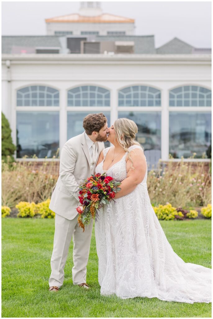 wedding couple share kiss outside front of the Sandusky Yacht Club