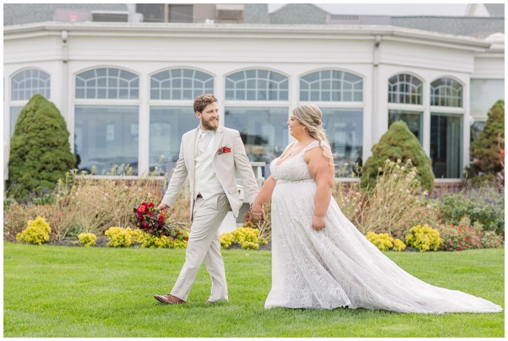 wedding couple walking outside in front of the Sandusky Yacht Club in Ohio