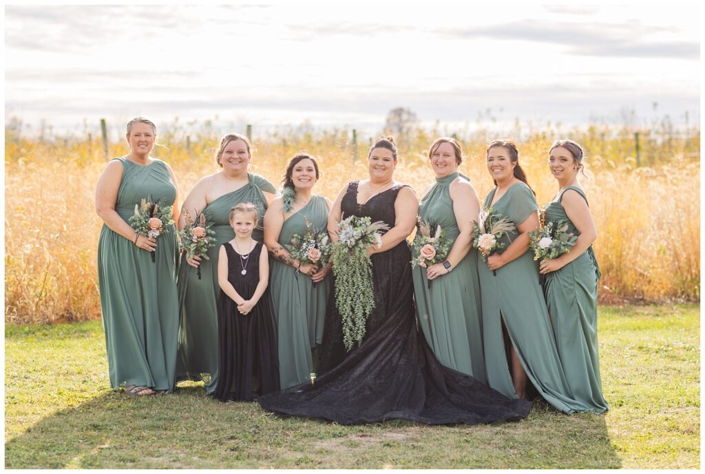 bridal party posing outside together for Pickwick Place fall wedding