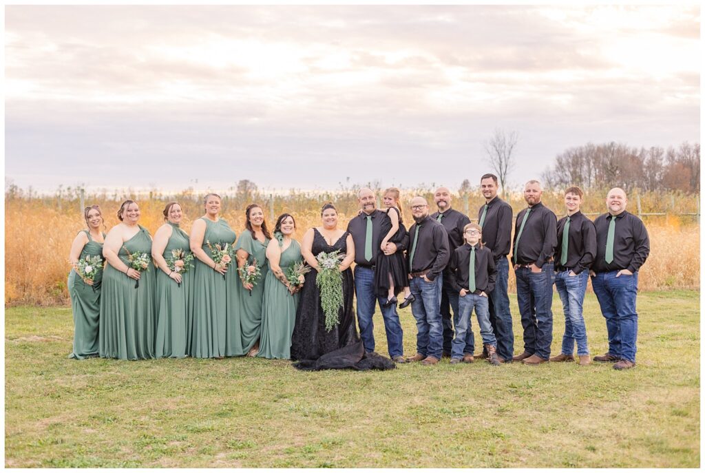 full wedding party all posing outside for fall ceremony at Pickwick Place