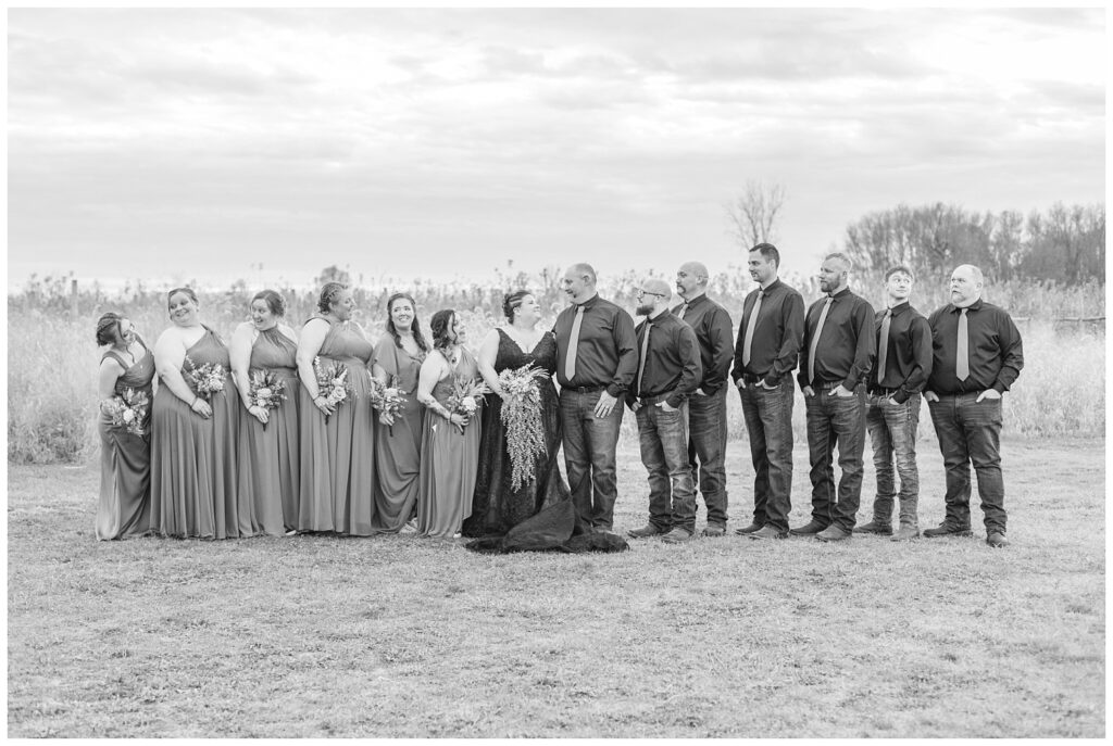 full wedding party all posing outside for fall ceremony at Pickwick Place