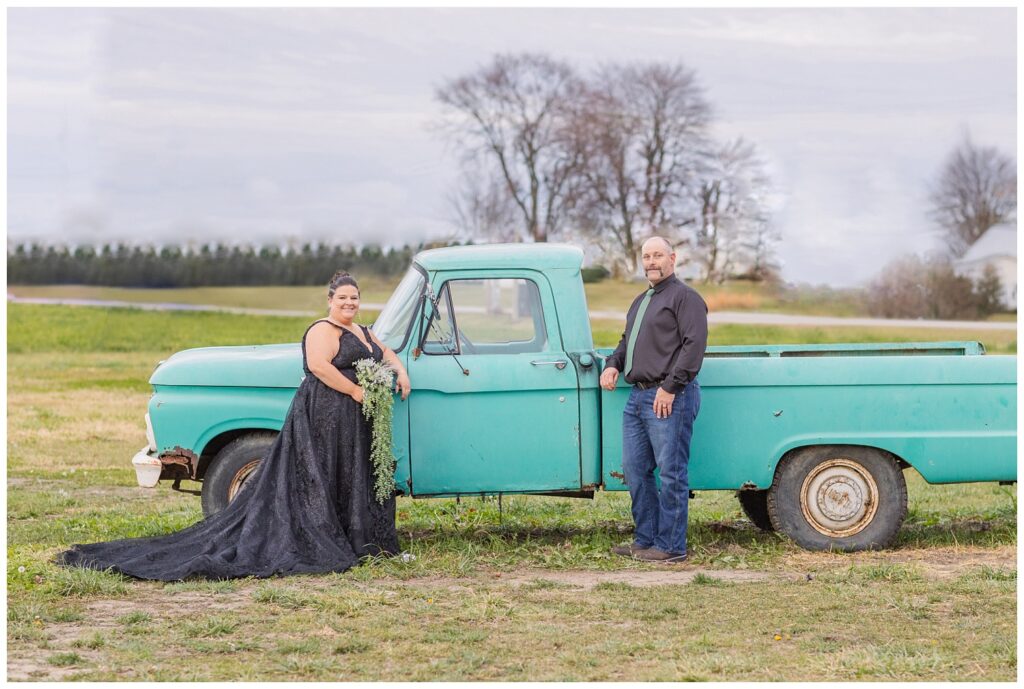 wedding couple posing next to an old teal green truck on the property at Pickwick Place in Bucyrus, Ohio