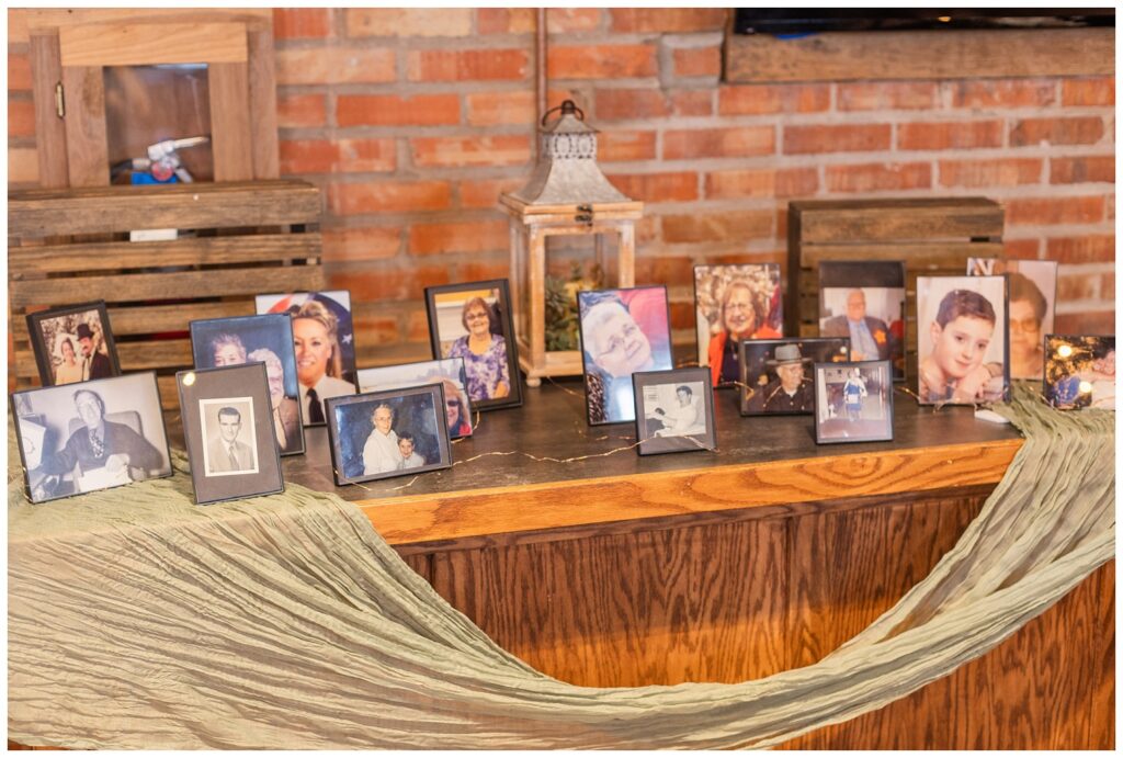 table of framed pictures of passed loved ones at Pickwick Place wedding reception