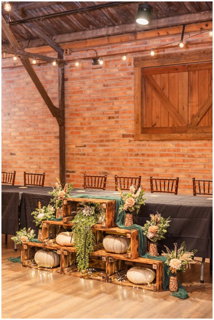 fall decorations in front of the wedding reception table at Pickwick Place venue