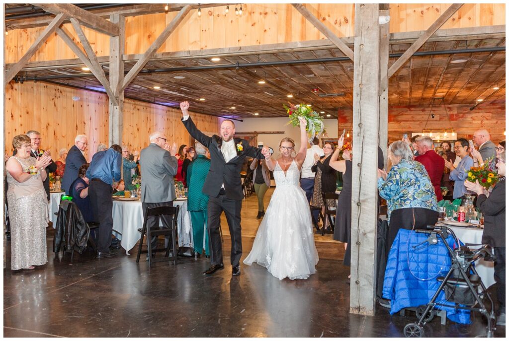 bride and groom making entrance into the reception at the Village Barn venue