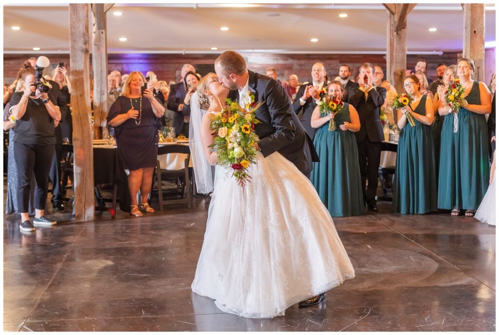 groom dipping back the bride for a kiss on the dance floor at wedding reception