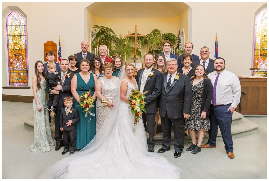 large family portrait with the bride and groom at the church in Monroeville, OH