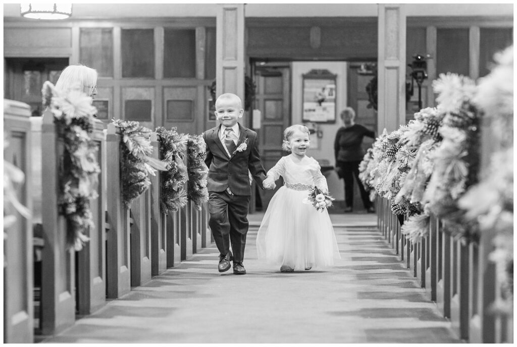 ring bearer and flower girl holding hands and walking down the aisle at Fremont, Ohio ceremony