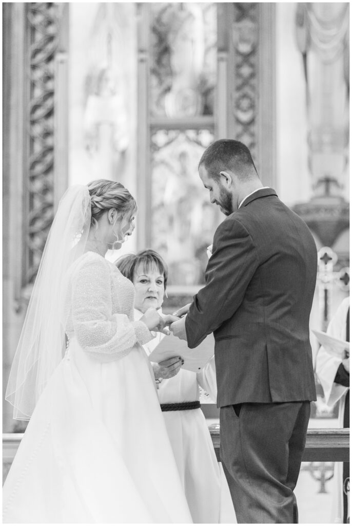 wedding couple exchanging rings in Fremont, Ohio church ceremony