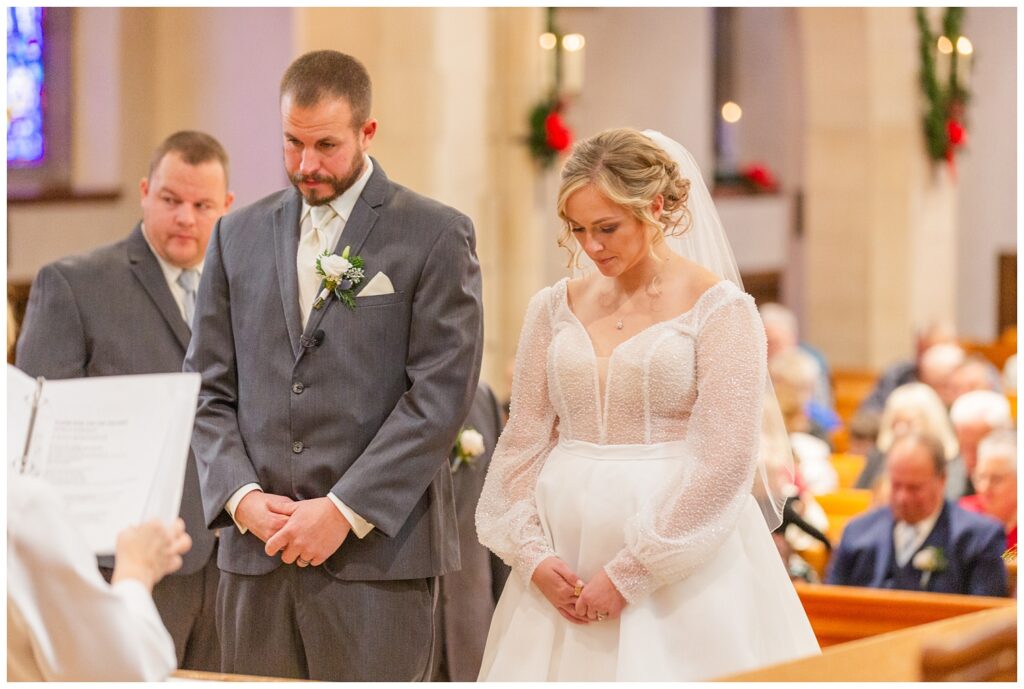 wedding couple praying during church ceremony in Fremont, Ohio