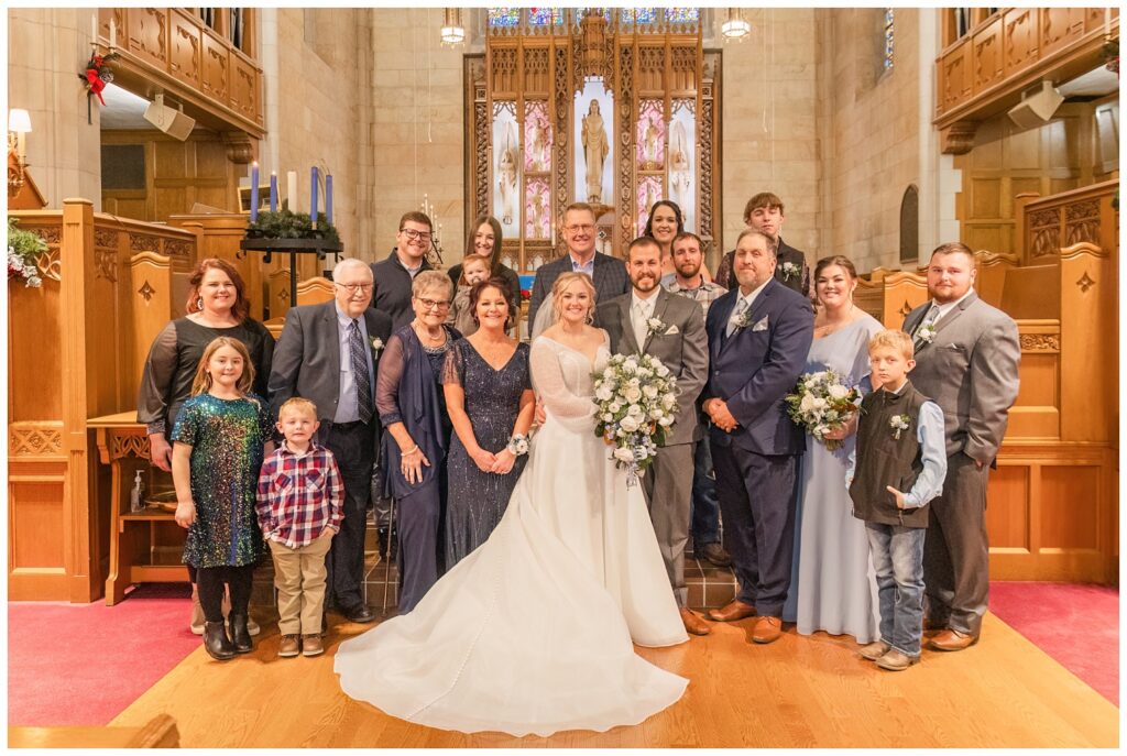 family portraits at church altar for winter wedding in Fremont, Ohio