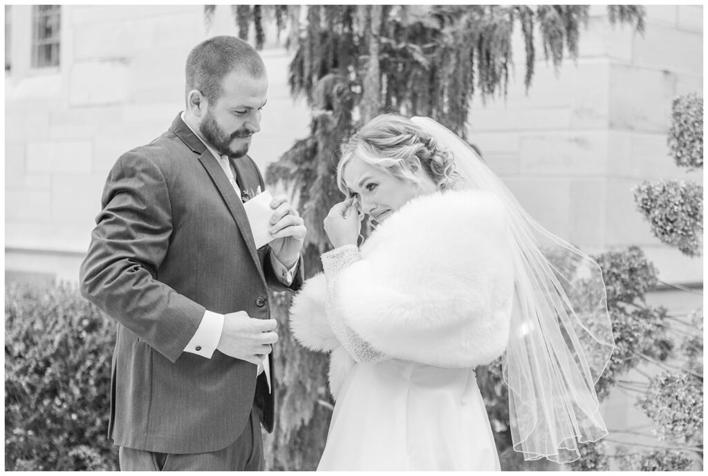 bride crying during her first look with the groom outside before the church ceremony