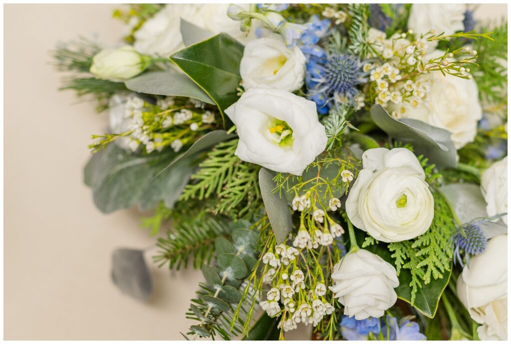 wedding bouquet with white and blue flowers and greenery