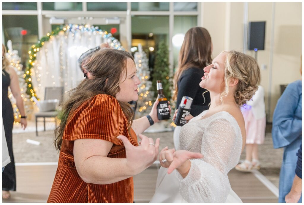 bride and her friend dancing at winter reception in Fremont, Ohio