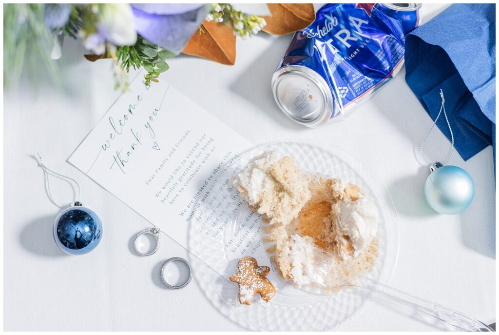 trash the wedding picture featuring cake, rings, beer can, blue ornaments and napkin