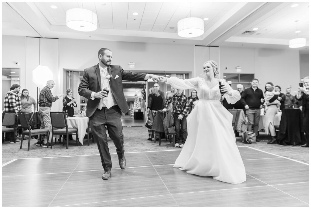 bride and groom walking into the reception with drinks at Neeley Center