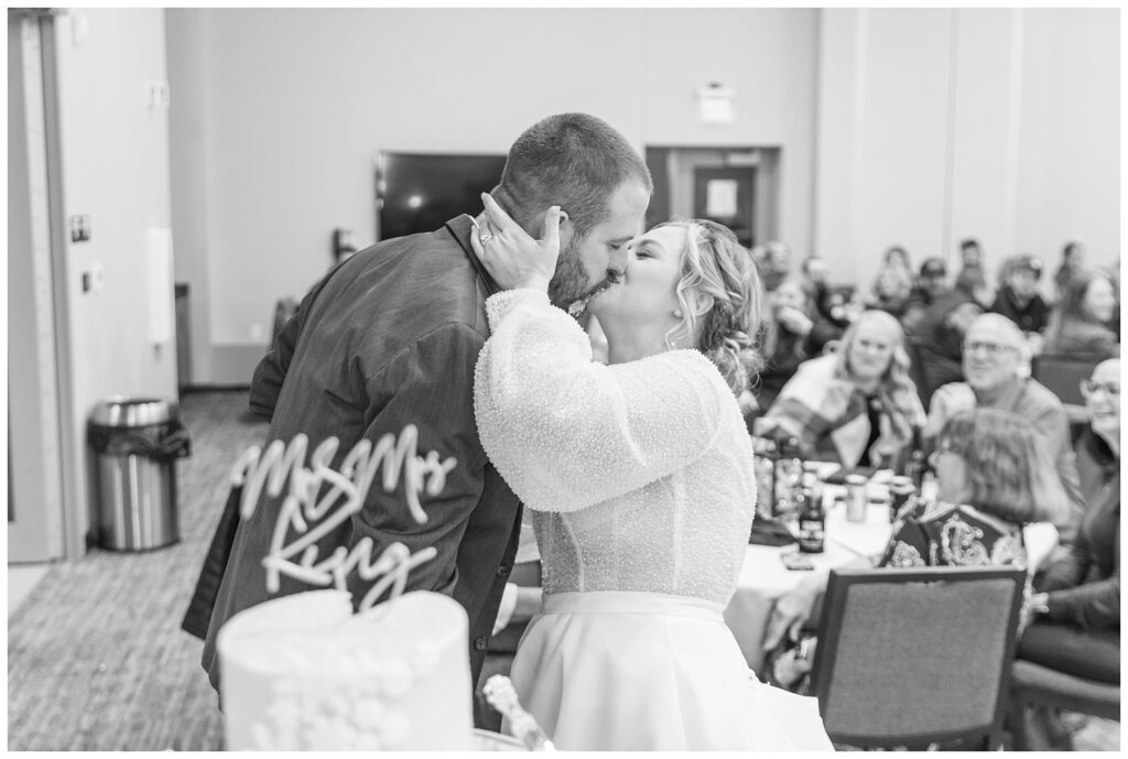 bride and groom kiss after cake cutting in Fremont, Ohio reception