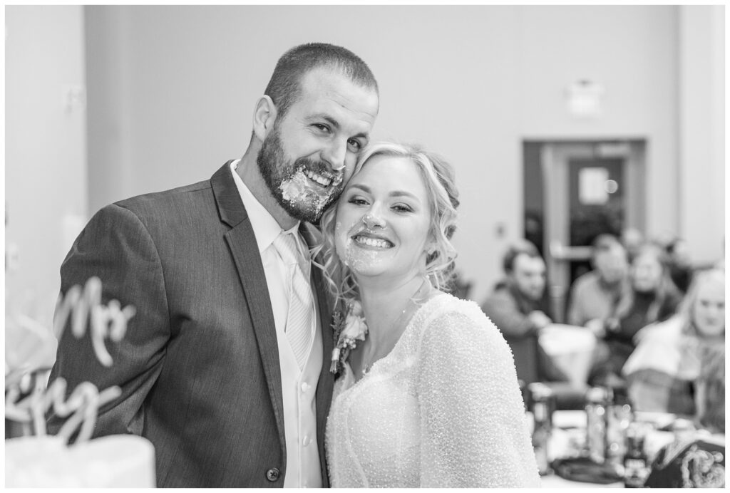 wedding couple showing their cake smashed faces at winter reception in Fremont, Ohio