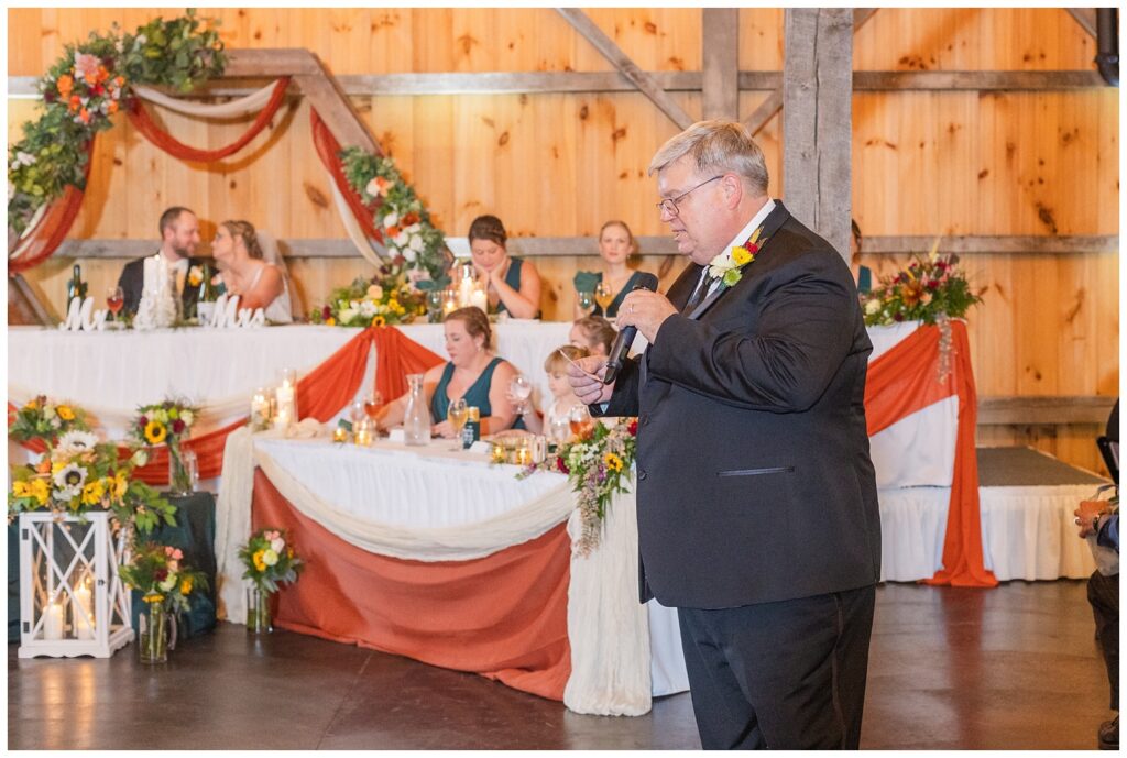 bride's dad giving the toast and speech for the couple at the reception