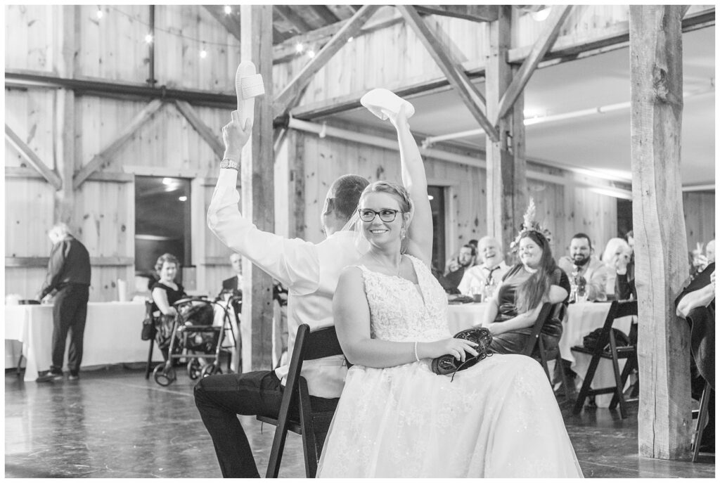 bride and groom play the shoe game on the dance floor during the reception