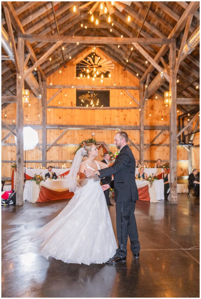 groom and bride have first dance at the Village Barn wedding venue 