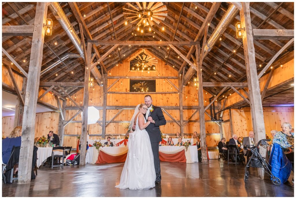 bride resting her head on the groom's chest while they dance during the reception