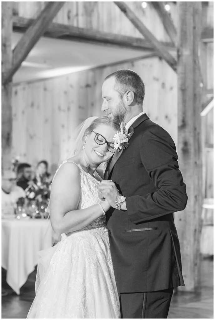 bride resting her head on the groom's chest while they dance during the reception