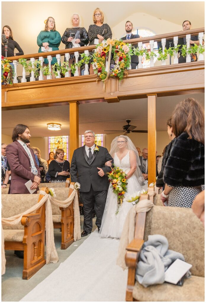 bride walking down the aisle with her dad at Monroeville, OH church ceremony