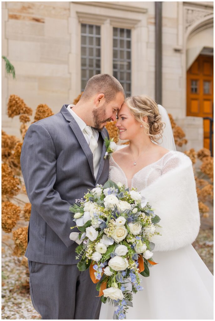 bride and groom touching foreheads outside for pre-ceremony portraits 