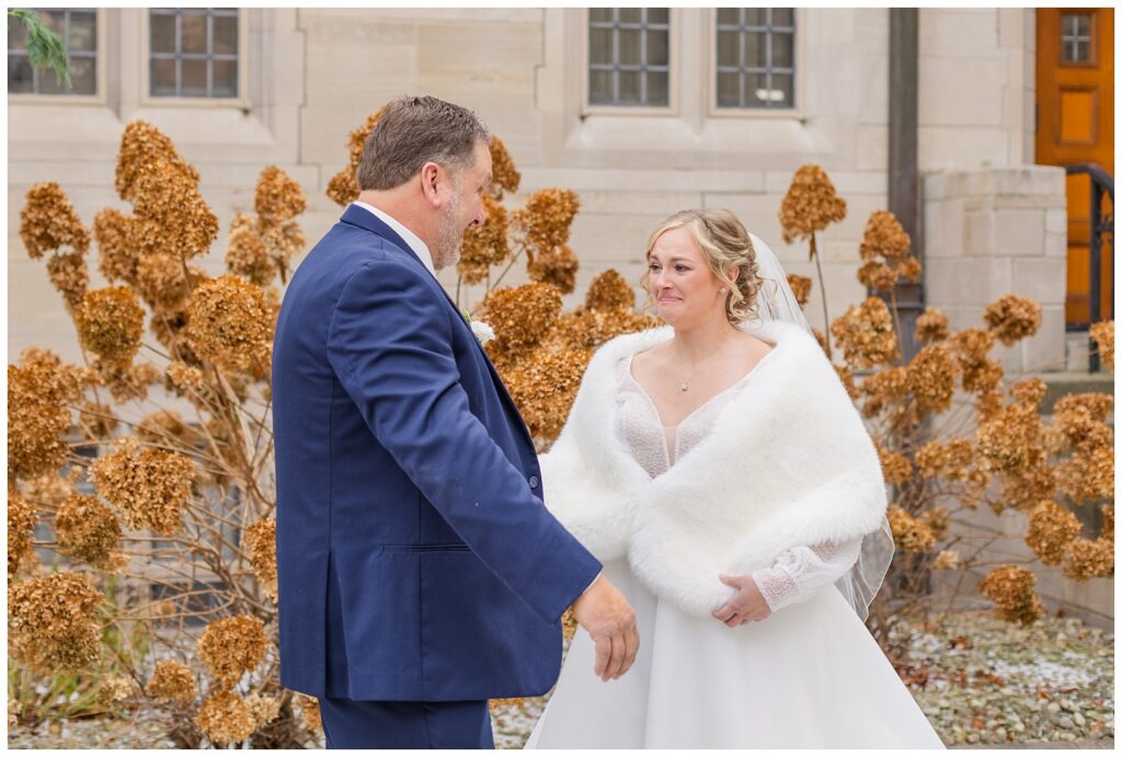 bride crying after her dad turns around  to see her during outside first look 