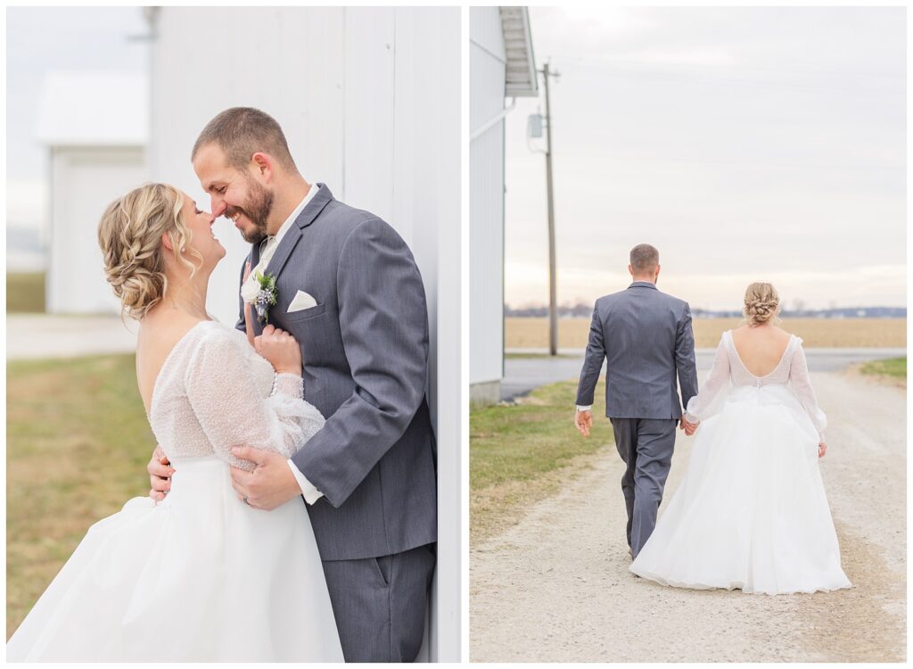 bride and groom walking away on a dirt road next to a white barn