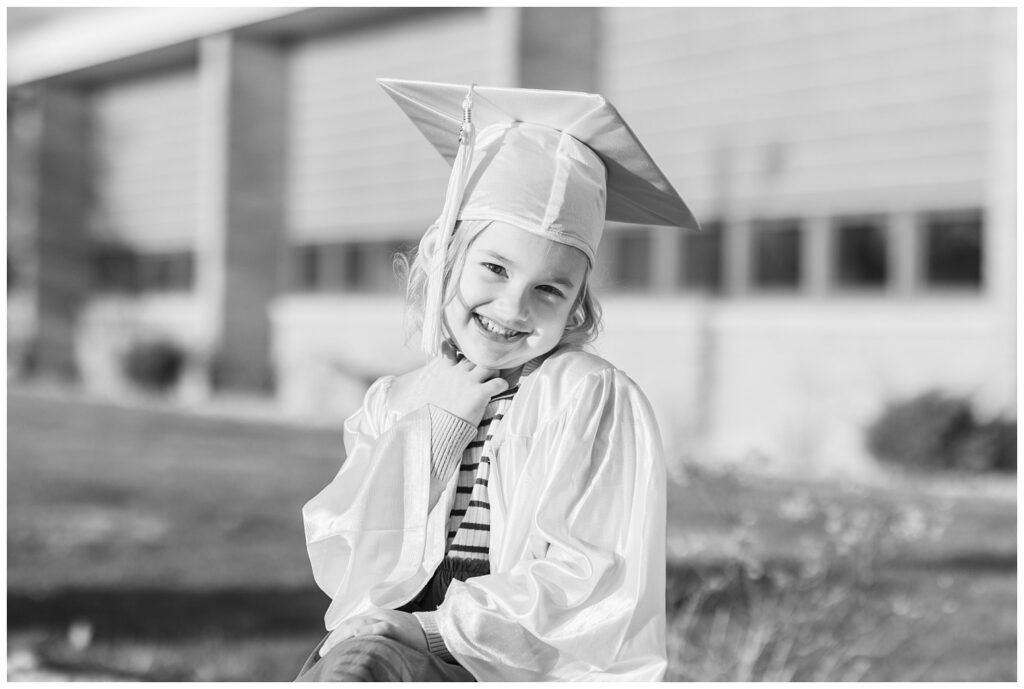 girl smiling and posing for graduation cap and gown minis in Tiffin, Ohio